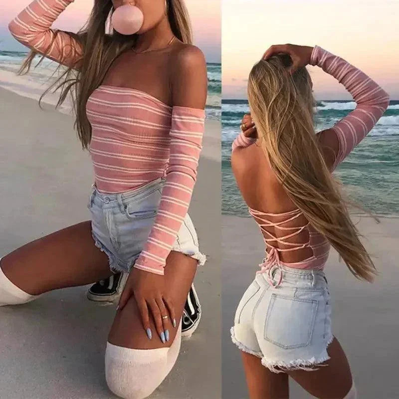 Woman wearing a casual pink backless striped bodysuit with lace-up detail and skinny fit on beach