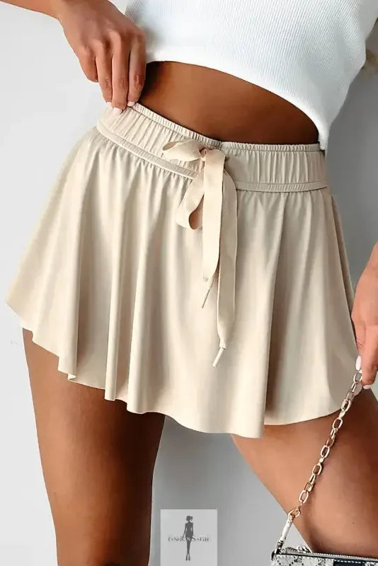 Beige drawstring high waist lined tennis skirt with mini length and adjustable waist