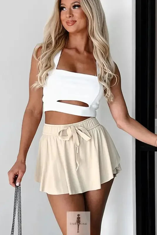 Beige drawstring high waist lined tennis skort with white crop top for activewear style