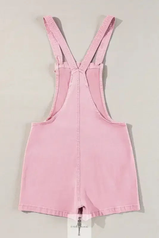 Pink denim romper with shorts and pockets displayed in the product image