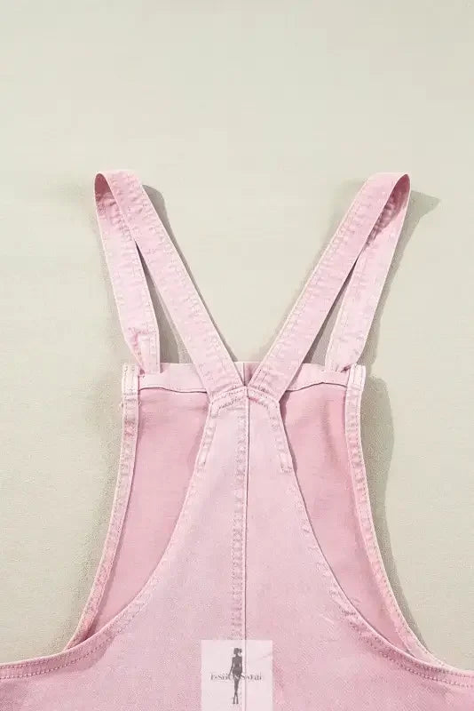 Pink denim romper with pockets showcasing stylish pink denim overalls