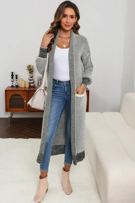 Woman wearing a fashionsarah gray and white knit pocketed duster cardigan