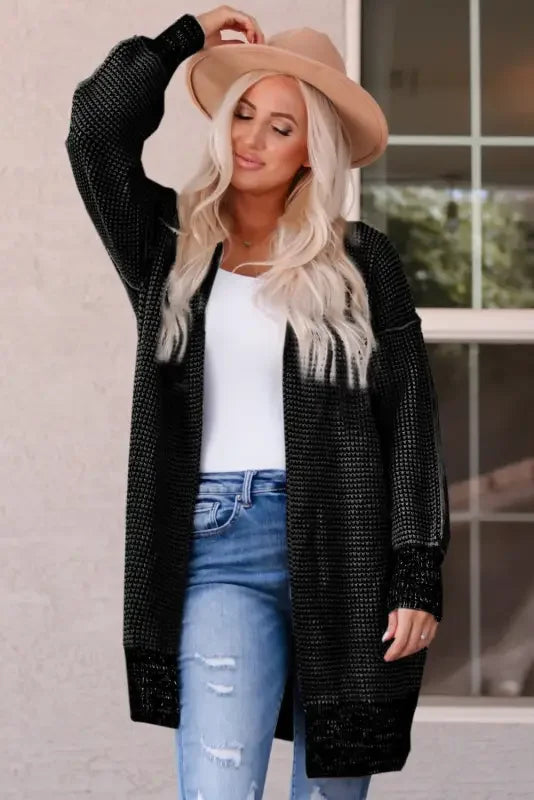 Woman wearing a fashionsarah gray and white duster cardigan with knit pockets and jeans