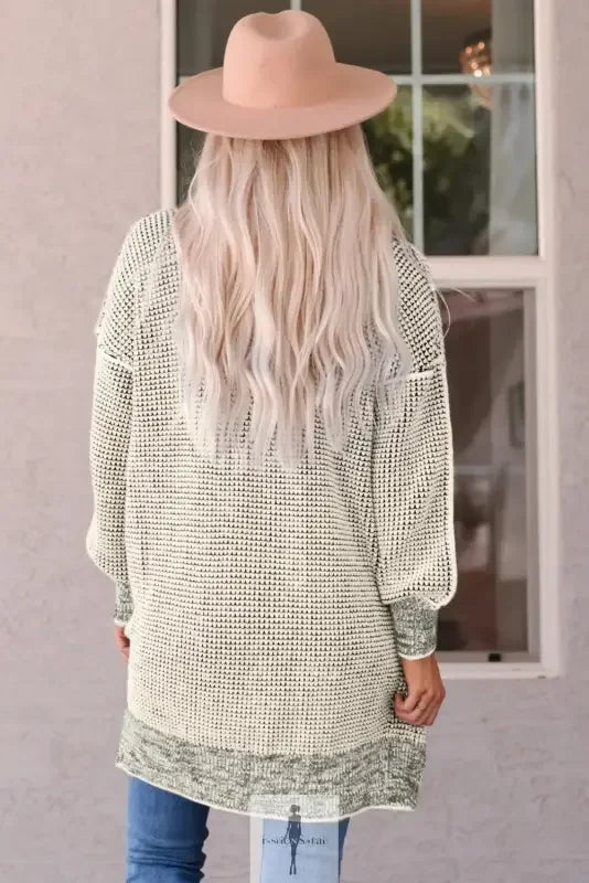 Woman wearing a fashionsarah gray and white duster cardigan with a hat