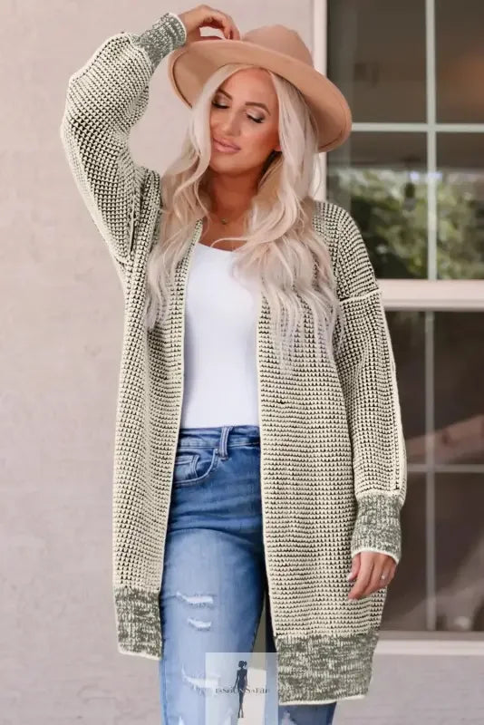 Woman wearing a fashionsarah gray and white duster cardigan with a patterned knit design