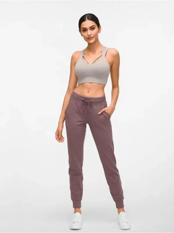 Woman wearing dark gray tied joggers with pockets from Fashionsarah online boutique