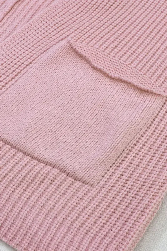 Pink oversized sweater cardigan with knitted pocket showcased at online boutique