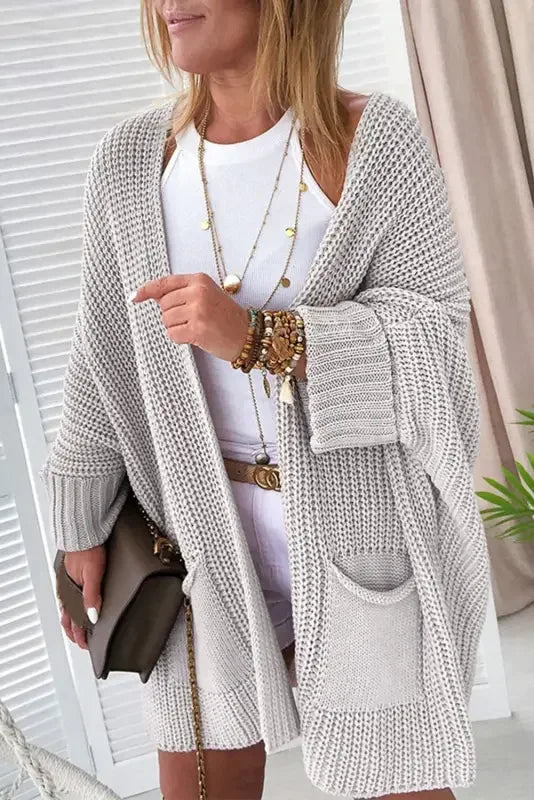 Pink oversized knit sweater cardigan from an online boutique, perfect for cozy style