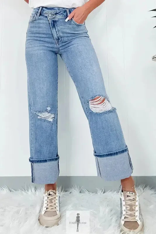 Blue high rise ripped jeans with distressed cuffs and light wash, stylish and trendy