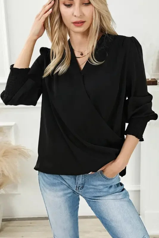 Woman wearing Black Shirred Cuffs Draped Blouse with solid surplice neck and jeans