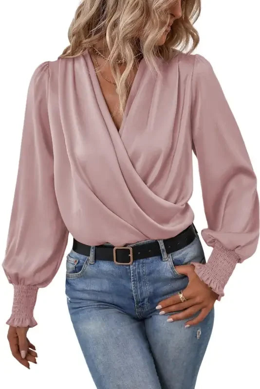 Pink satin wrap blouse with solid surplice neck and shirred cuffs draped design