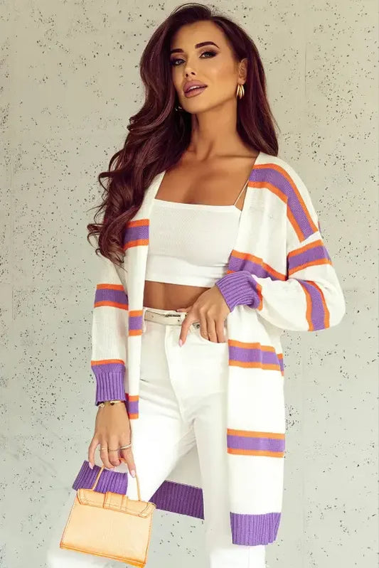 Woman wearing a multicolor striped cardigan with purple and orange stripes
