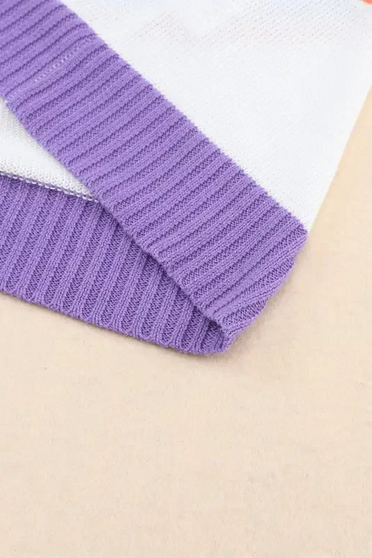 Purple and white knit fabric from a multicolor striped cardigan display