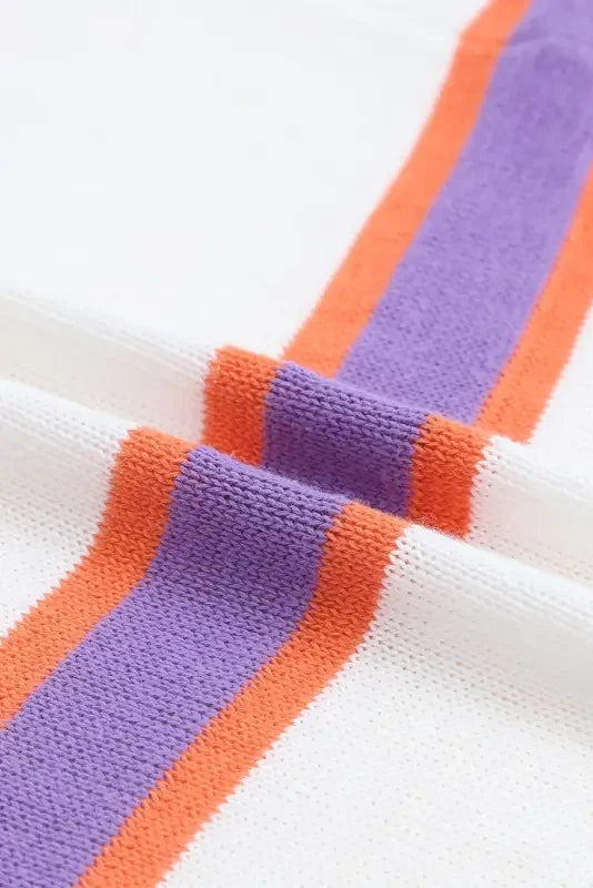 White knit fabric with purple and orange stripes on multicolor striped cardigan