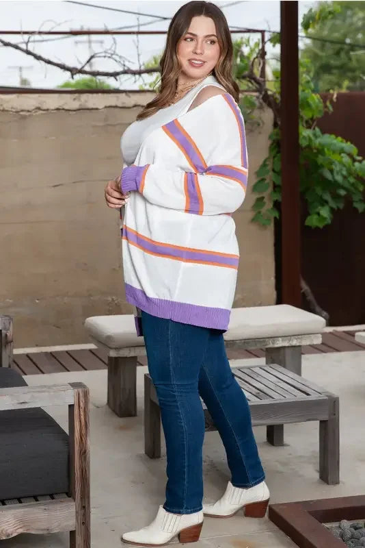 Woman wearing a multicolor striped cardigan, showcasing its stylish striped design