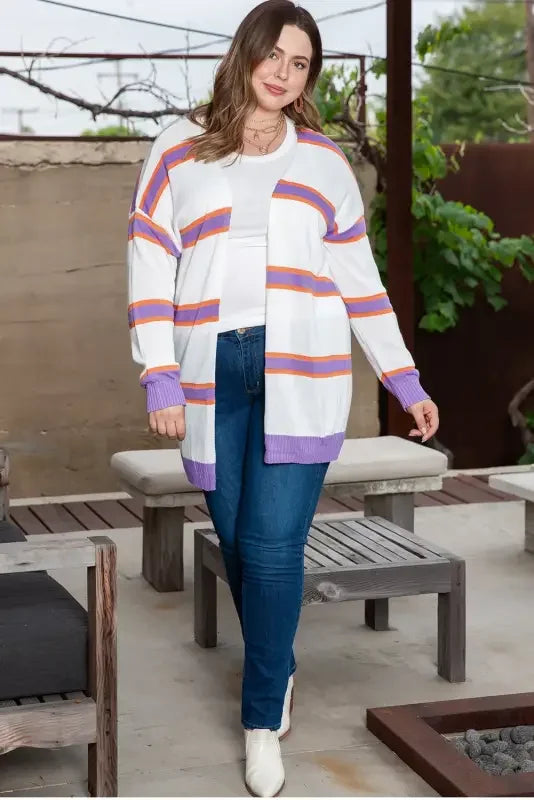 Woman wearing a multicolor striped cardigan, showcasing the fashionable striped cardigan