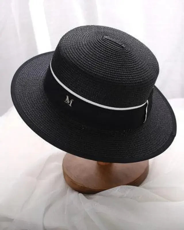 Black straw boater hat with white trim, perfect for stylish beach sun hats and sun hats