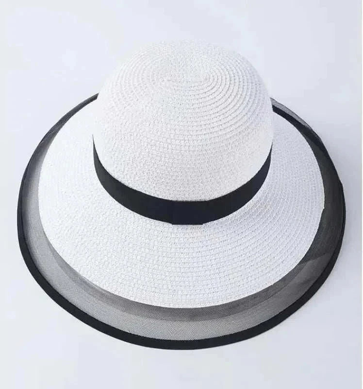 White summer sun hat for women with black trim and wide brim made of straw and nylon