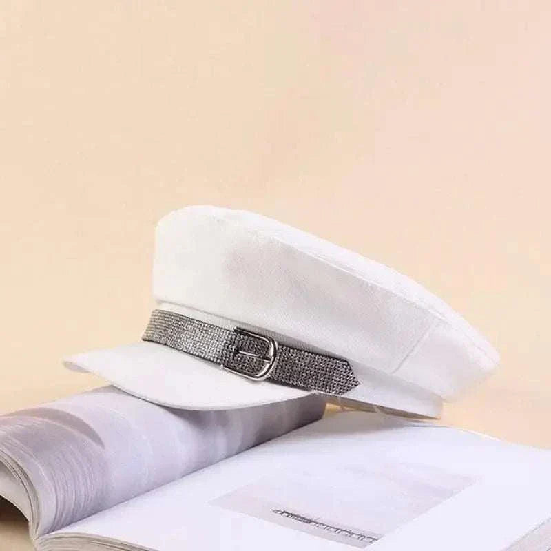 White rhinestone cadet hat with silver band and brim on book background