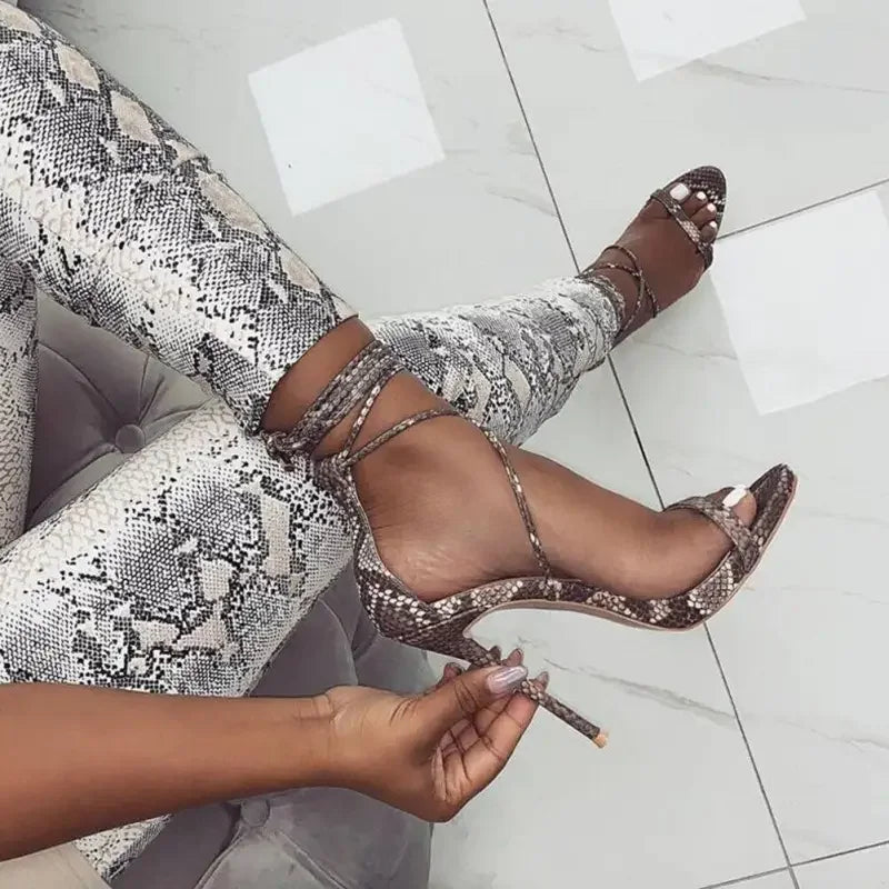 Snakeskin print high heels featuring a stylish lace-up heel design for elegant footwear
