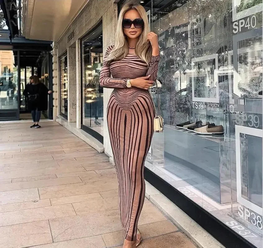 Long striped sheer sheath dress showcased in women’s fashion at Online Boutique