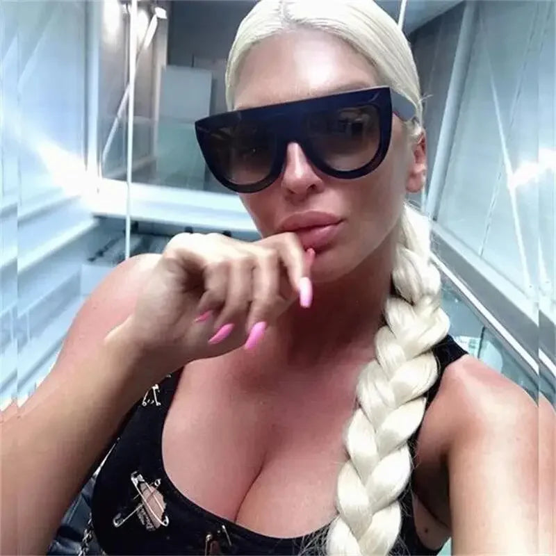 Blonde woman wearing oversized sunglasses at Black Sunglasses Online Fashion Boutique