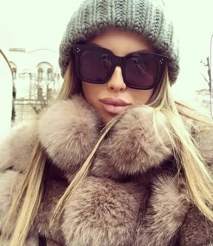 Woman in fur coat wearing Black Luxury Square Sunglasses showcasing luxury square sunglasses fashion