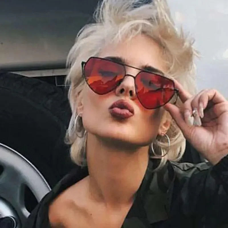 Woman with red Heart Shaped Sunglasses showcasing stylish eye sunglasses design