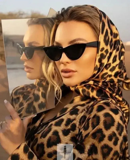 Woman with leopard print headscarf and vintage cat sunglasses in a stylish fashion image