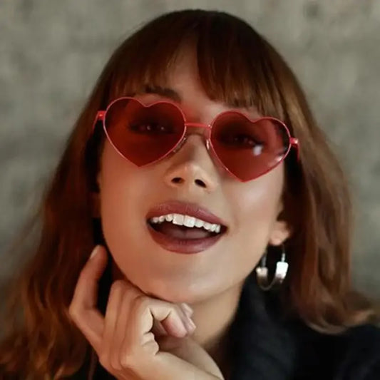 Red heart-shaped sunglasses featured on a Blonde Woman in Heart Love Sunglasses collection