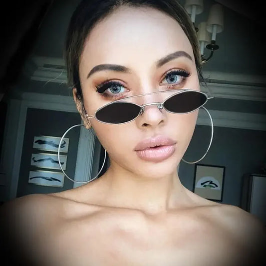 Woman wearing Gold Framed Diamond Oval Sunglasses from online boutique for women’s fashion