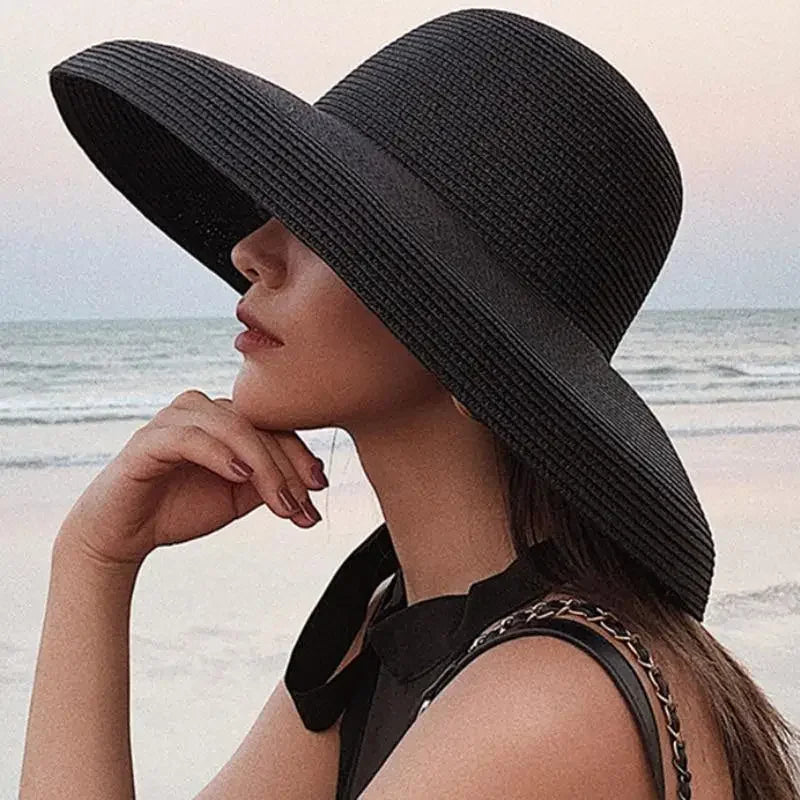 Black wide-brimmed straw beach hat for ladies, perfect for sun protection and style