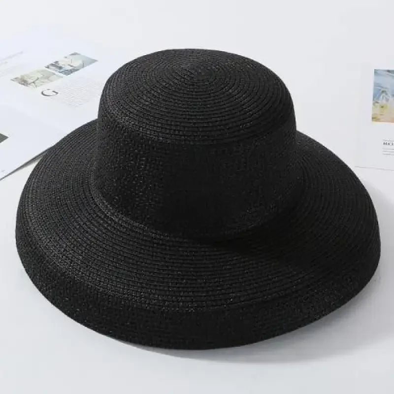 Black woven straw beach hat for ladies, perfect for stylish summer outings