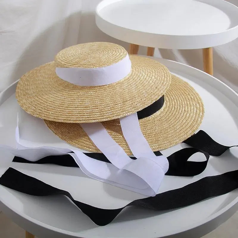 Pair of wide brim straw hats with contrasting ribbons ideal for summer fashion