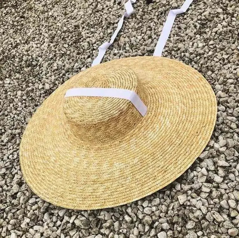 Wide brim straw hats featuring a white ribbon for sun protection and style