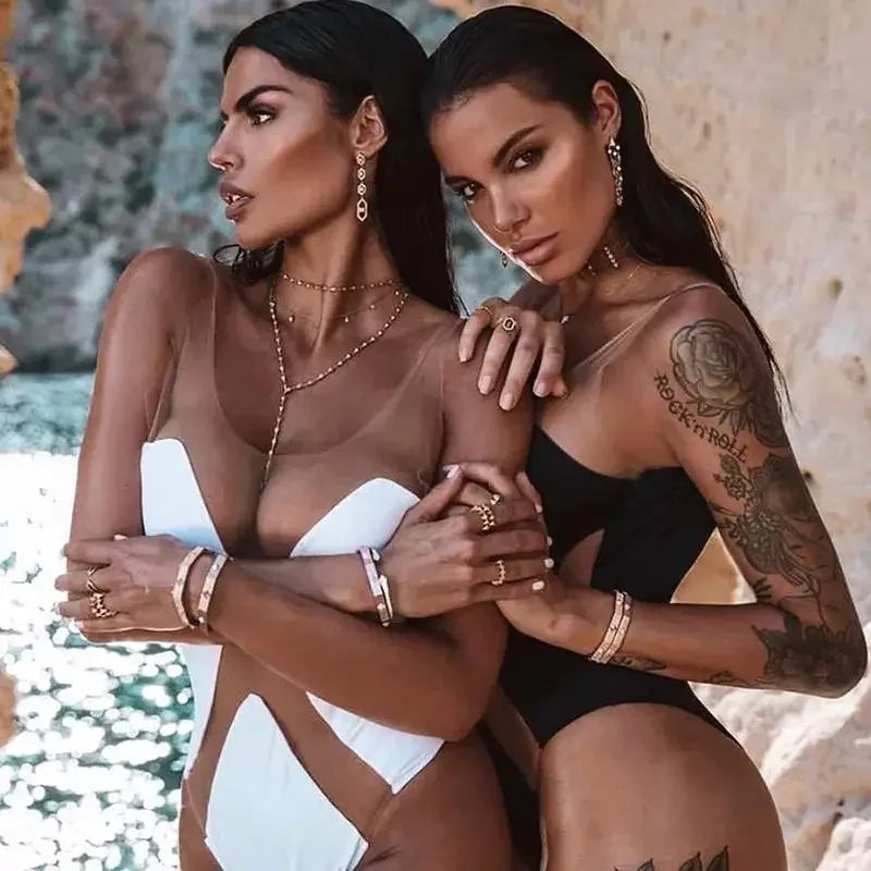 Two women in swimwear and jewelry wearing transparent monokini from online boutique women’s fashion