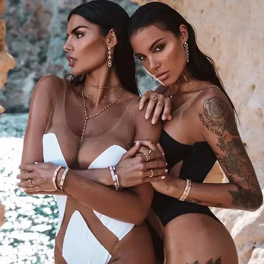 Two women in swimwear and jewelry wearing transparent monokini from online boutique women’s fashion