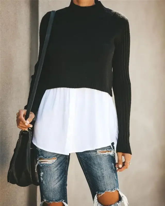 Chic layered knit sweater shirt look with black sweater over white shirt and ripped jeans