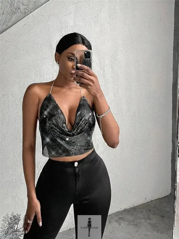 Woman in a sparkly halter top paired with black pants showcasing the Shiny Camis Top