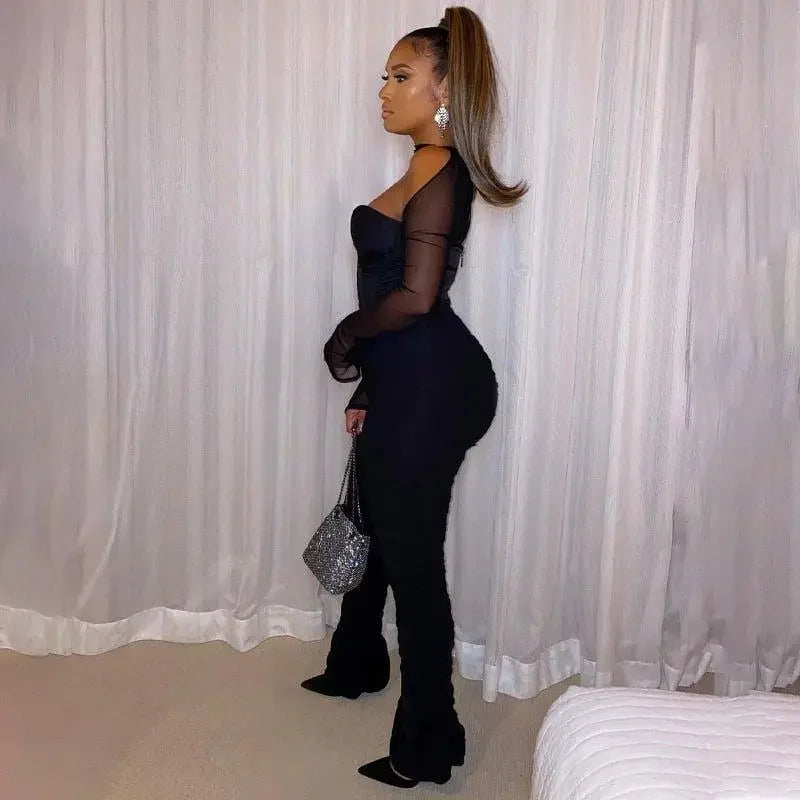 Woman in black jumpsuit available at online boutique, perfect for women’s fashion enthusiasts