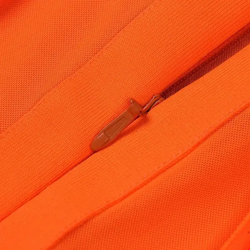 Orange fabric with zipper detail from the Tassel Orange Elegant Dress, an orange elegant dress