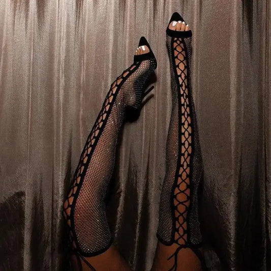 Sparkly fishnet thigh-high heels with crystal cross tied design on Over-The-Knee Cross Tied Boots