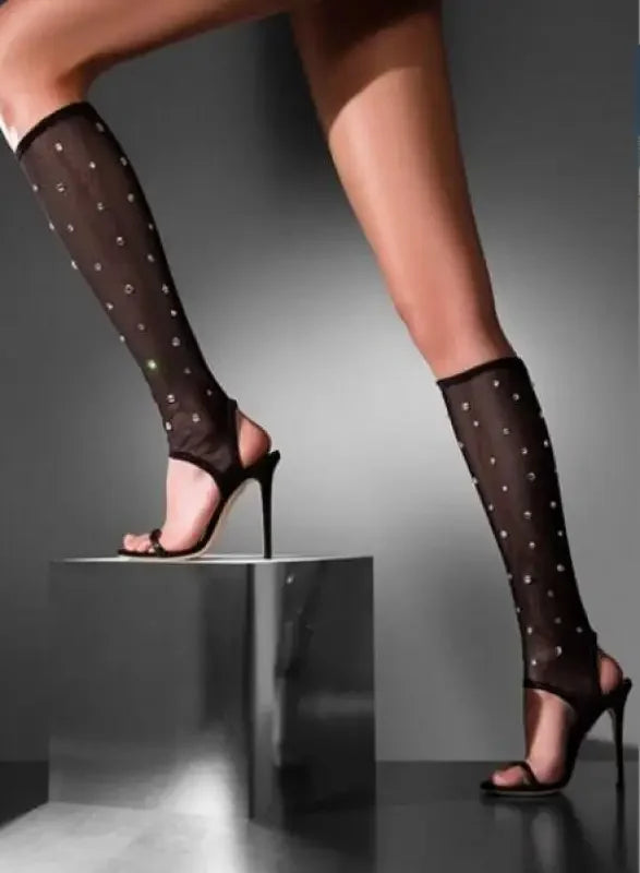 Women Sparkly Boots featuring black stiletto heels and studded gladiator boot leg coverings