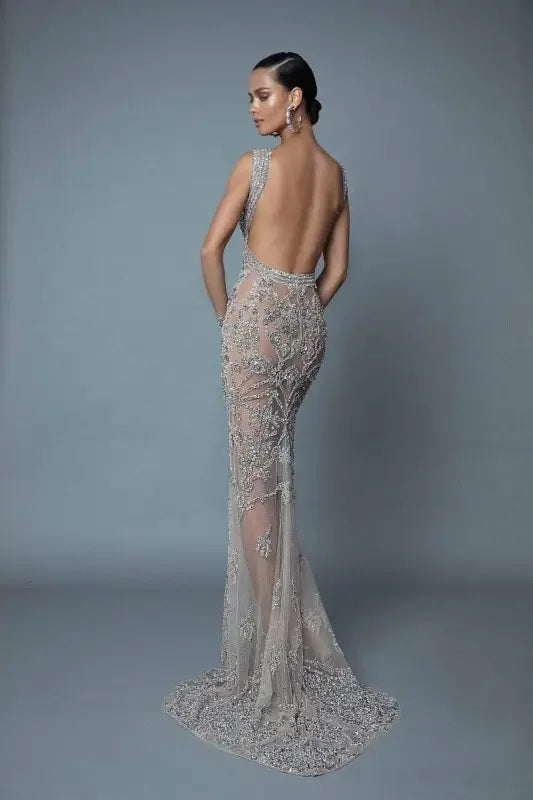 Glamorous evening dress featuring a backless, beaded, sheer design for a stunning look
