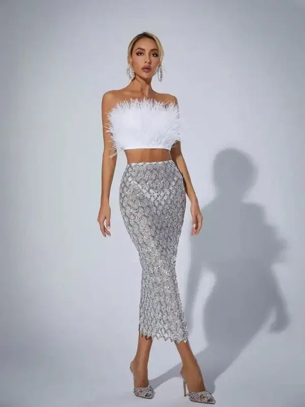 Woman wearing white feather top and silver sequined skirt with pointed toe crystal transparent pumps