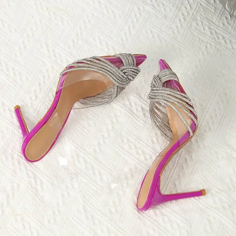 Pair of pink pointed toe crystal transparent pumps with rhinestone straps