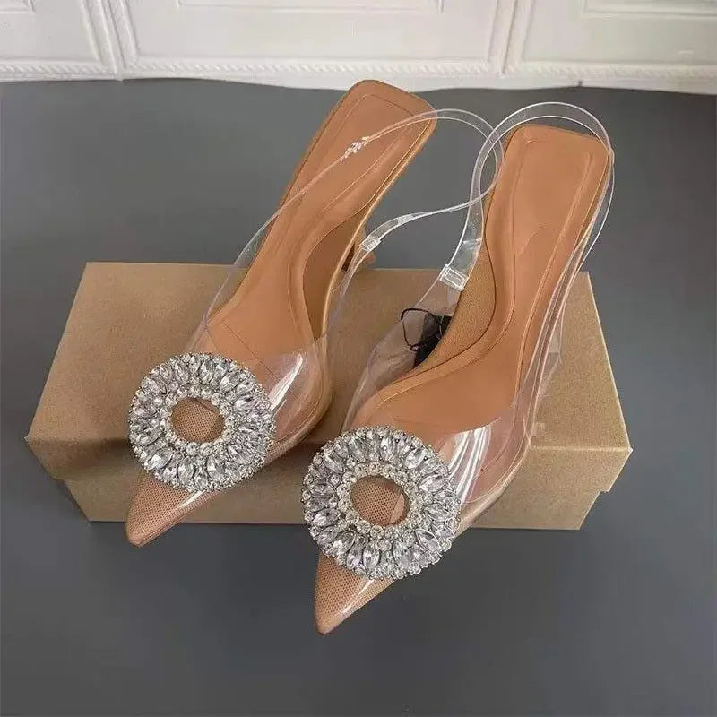 Pair of nude pointed toe crystal transparent pumps with rhinestone embellishments