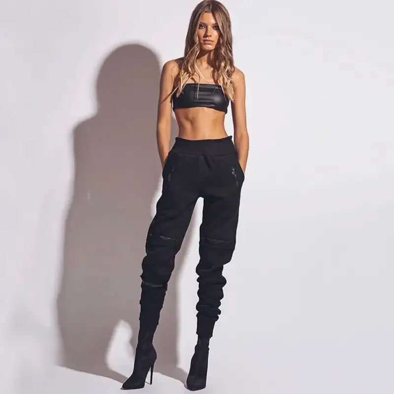 Woman wearing black casual fitness pants with attached boots, ideal for casual fitness activities