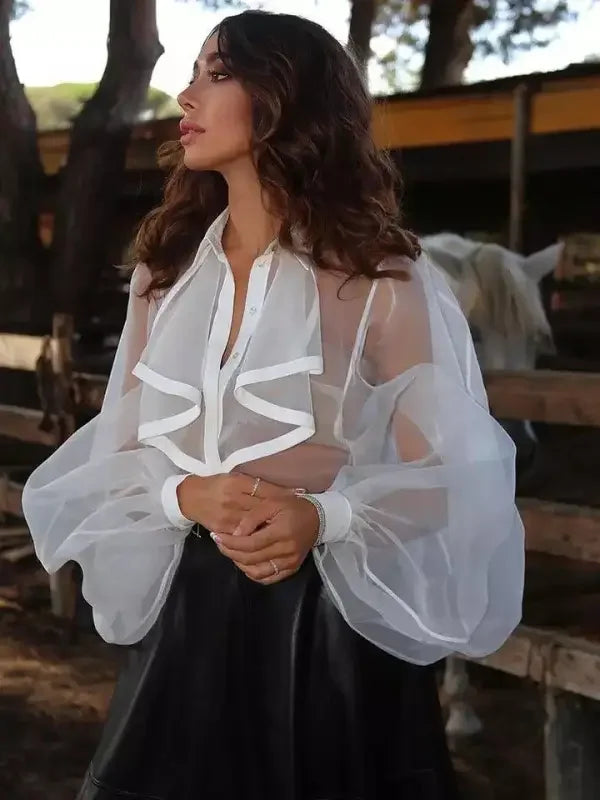 Woman wearing a ruffles turndown collar loose bodysuit with sheer white blouse and black skirt