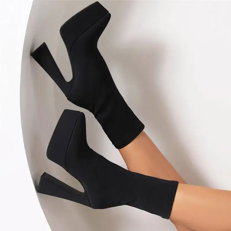 Luxury sock platform boots featuring sleek black platform ankle footwear